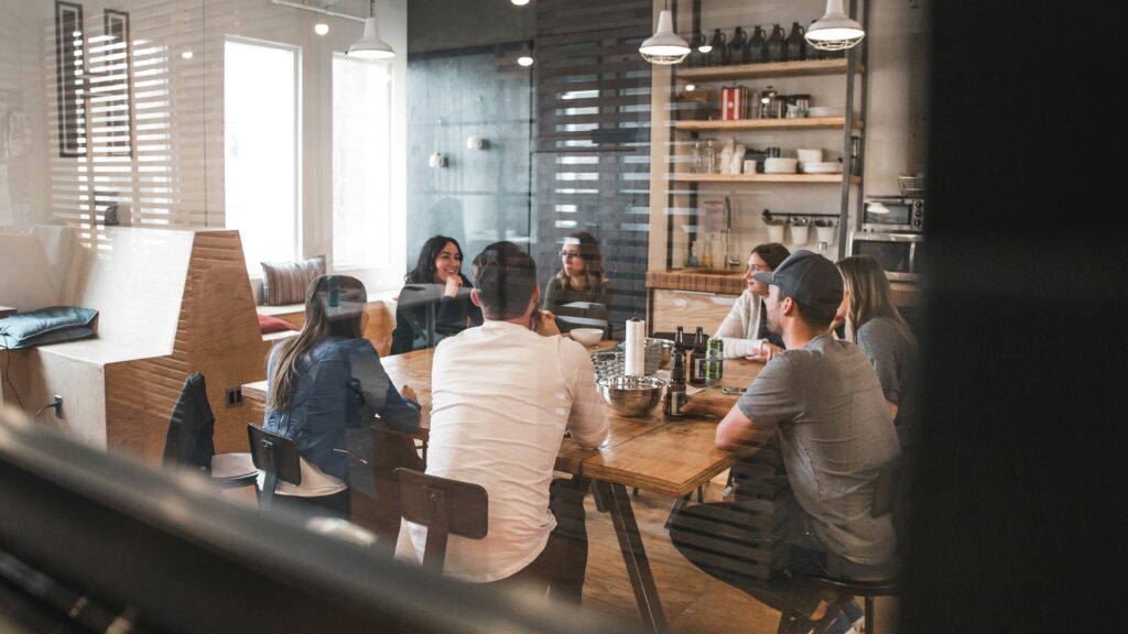 Team members gathered around a conference table for a collaborative workplace meeting